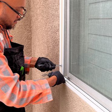 Man installing or repairing a window screen.