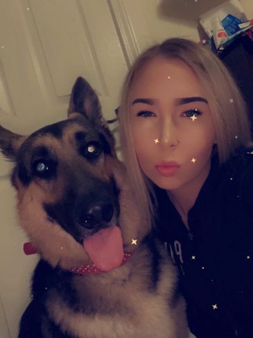 Briana, Bather for Muddy Paws Grooming Salon, with her pup.