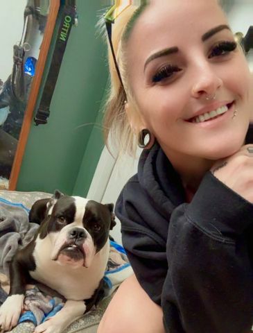 Chelsea, Dog Groomer for Muddy Paws Grooming Salon, with her pup.
