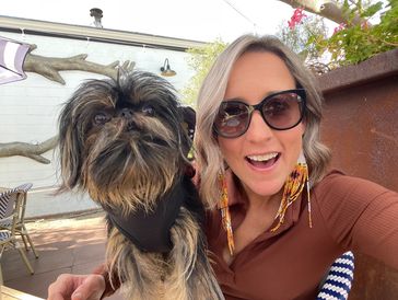Jenny, owner and lead groomer for Muddy Paws Grooming Salon, with her furry best friend Maggie.