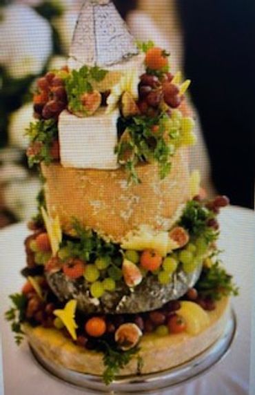 Multi-tiered cheese wheel display.