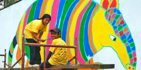 students helping to paint the mural on Jenkins Ave