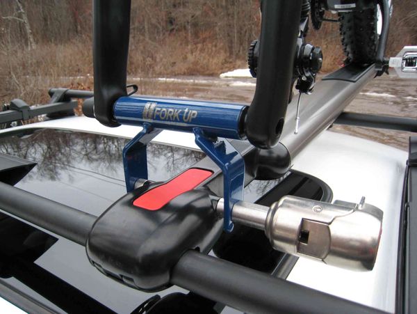 Bike front fork adapter for roof racks or storage.