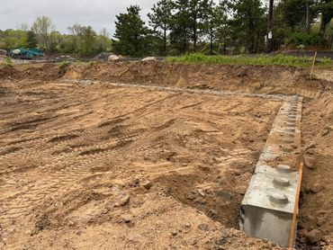 Setting foundation blocks for a retaining wall system in Richmond, RI.