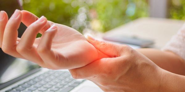 A man holding his hand with another hand