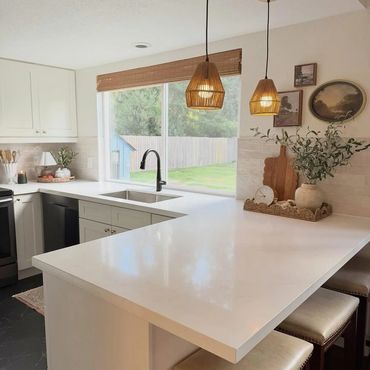 Bright kitchen with white countertops, and pendant lights in Port Orchard, Washington.