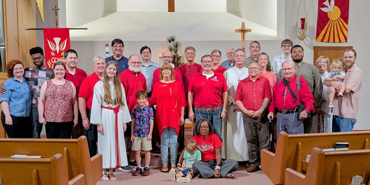 A diverse church group posing together inside a sanctuary.