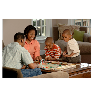 Family enjoying a board game together in a cozy living room.
