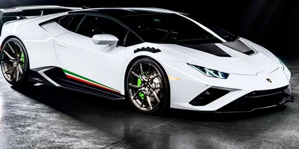 White Lamborghini sports car with Italian stripe detailing.