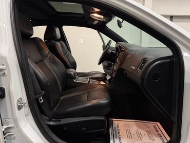 Clean car interior with black leather seats and dashboard.
