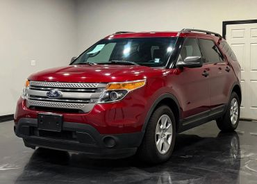 Red Ford SUV parked indoors with a shiny finish.