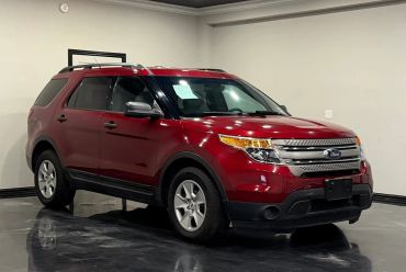 Red Ford SUV parked indoors on a shiny black floor.