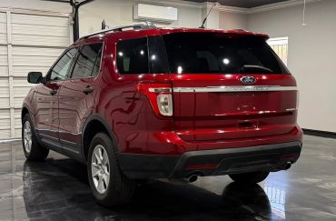 Red Ford Explorer SUV parked indoors on a polished floor.