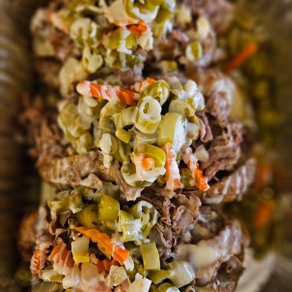 The Italian loaded potato with mild or hot peppers, white queso, with a ladle of Aju.