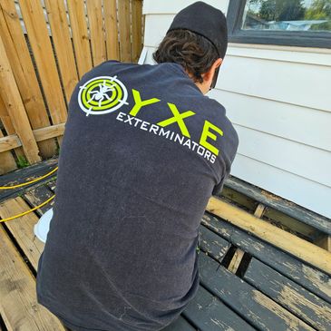 Person wearing a Termite Exterminators shirt.