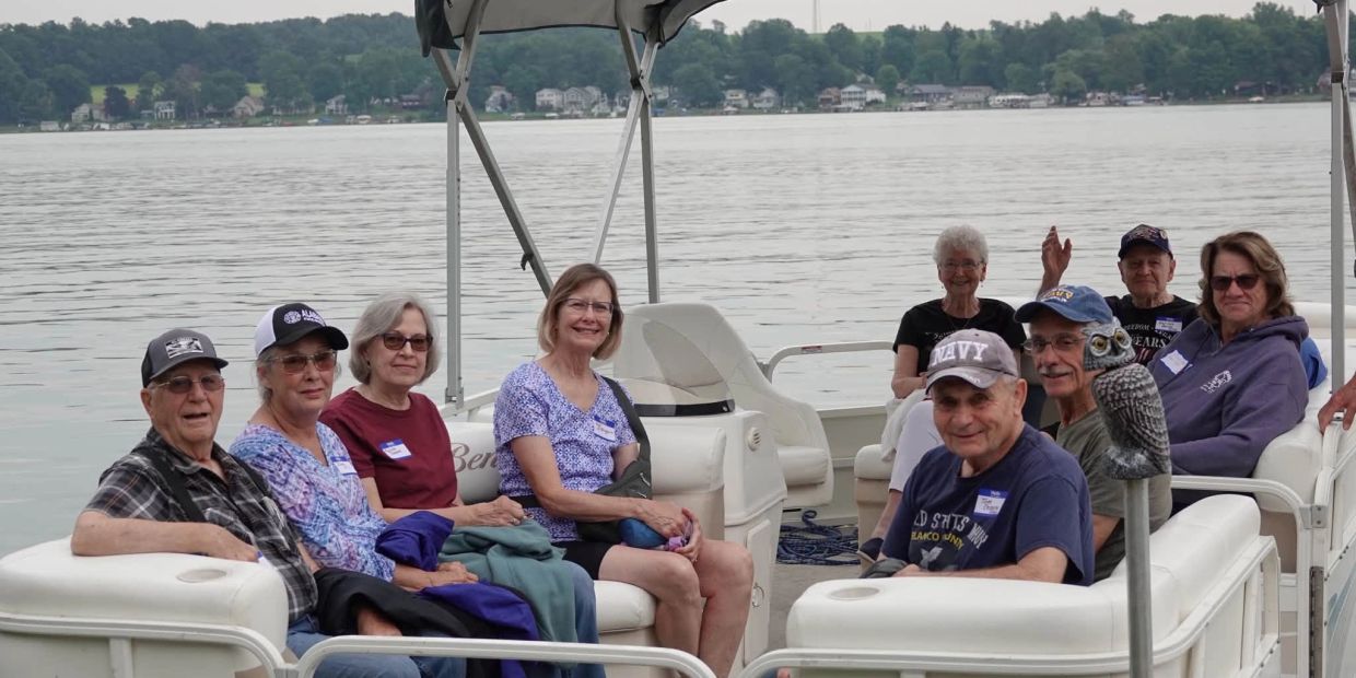 Group of people enjoying a boat ride on a lake.