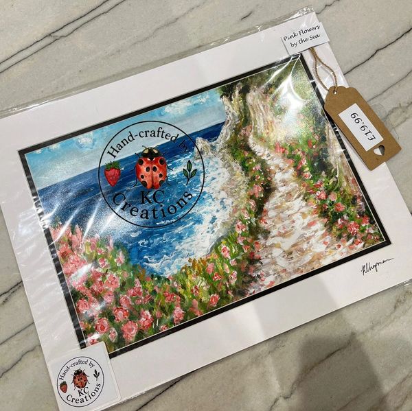 Hand-crafted scenic artwork of pink flowers by the sea, priced at £13.99.