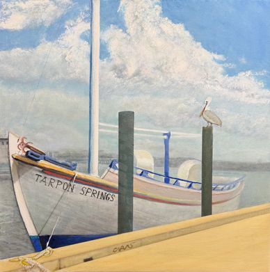 A painted boat named Tarpon Springs docked with a pelican perched on a post.