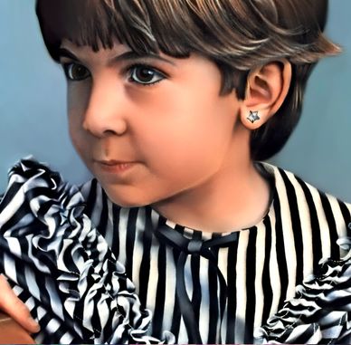 Close-up of a child with short hair wearing a striped shirt and star-shaped earrings.