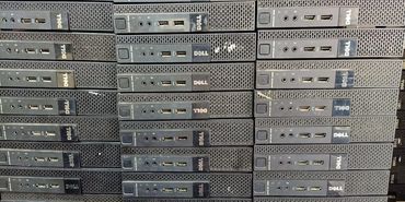 Stack of Dell desktop computer towers arranged in rows.