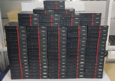 Stack of Lenovo ThinkCentre desktop computers arranged in rows.