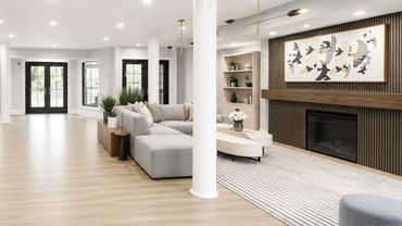 Renovated Windsor Leesburg resident lobby with oak floors and layered seating by Design by DuBois
