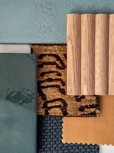 Design board with navy fabric, camel leather, patterned neutral, wood accent, teal and blue tile