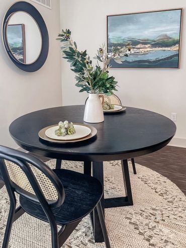 Model apartment living room with neutral furniture and wood accents – Altitude 970 Kansas City