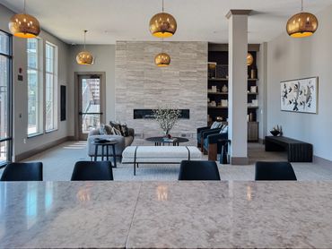 Multifamily clubroom with fireplace, curved seating, and layered textures – Altitude 970 Kansas City