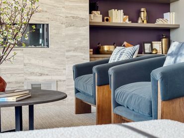 Multifamily clubroom with fireplace, curved seating, and layered textures – Altitude 970 Kansas City