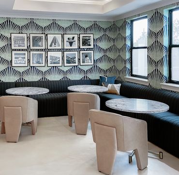 Resident lounge at Windsor Encore with communal seating, work-from-home zones, and graphic wallpaper