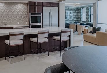 Resident lounge at Windsor Encore with communal seating, work-from-home zones, and graphic wallpaper