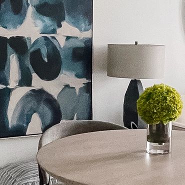 Model living room interior design with large abstract art and modern bar table in Atlanta.