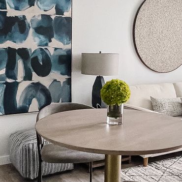 Model living room interior design with large abstract art and modern bar table in Atlanta.