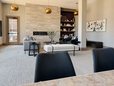 Multifamily clubroom with fireplace, curved seating, and layered textures – Altitude 970 Kansas City