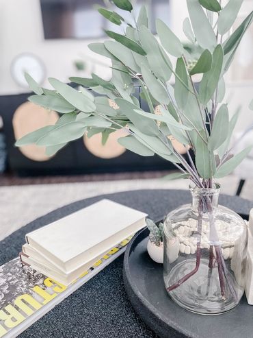 Model apartment living room with neutral furniture and wood accents – Altitude 970 Kansas City