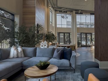 Clubroom renovation in Atlanta at a multifamily property with wood panels and deep blue upholstery