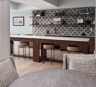 Clubroom kitchenette with geometric tile backsplash, bar seating, and open shelves – Leesburg VA