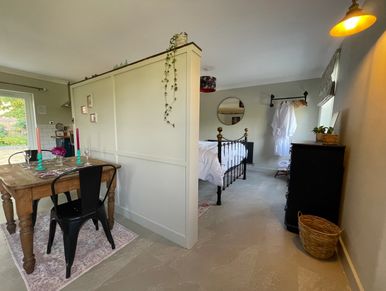 Cozy dining and bedroom area with rustic and modern decor.