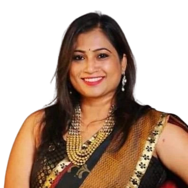 Smiling woman in traditional saree and jewelry.
