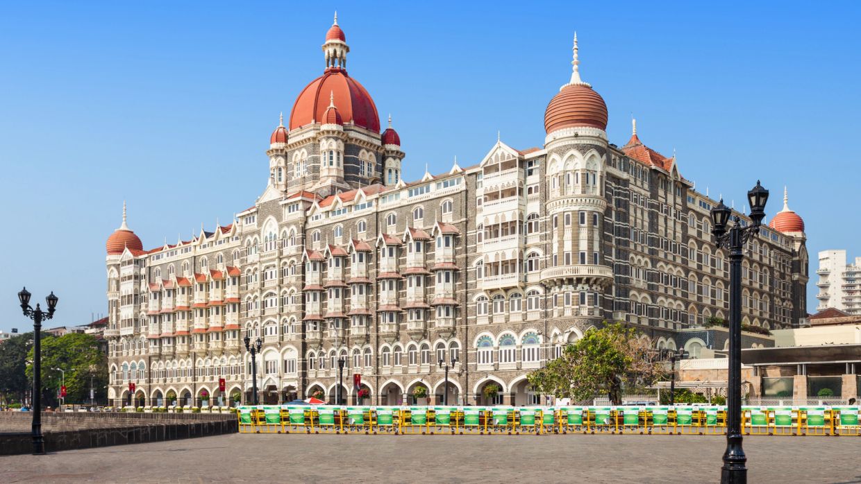 Historic hotel with distinctive domes under a clear blue sky.