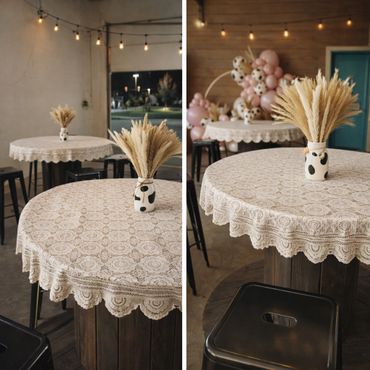 Cozy rustic tables with lace covers and dried flower centerpieces.
