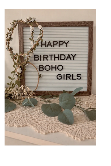 Rustic birthday sign with floral crown and greenery on lace.