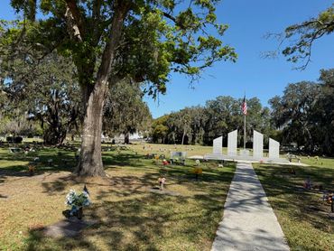 Walkway beneath live oaks leading to the veterans memorial at Beaches Memorial Park
