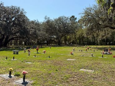 Flowers and memorial markers across the open burial gardens at Beaches Memorial Park