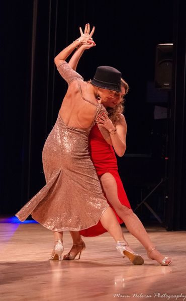 two women dancing tango on stage. tango queer