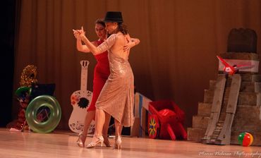 two women dancing tango on stage. tango queer Miami