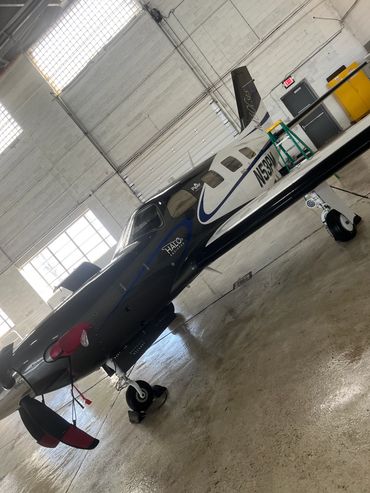 small private plane that was just washed and is ready for flight in a hangar
