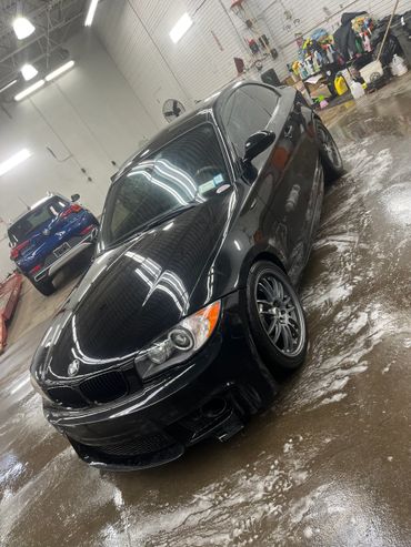 black bmw that was just washed, it is still drying