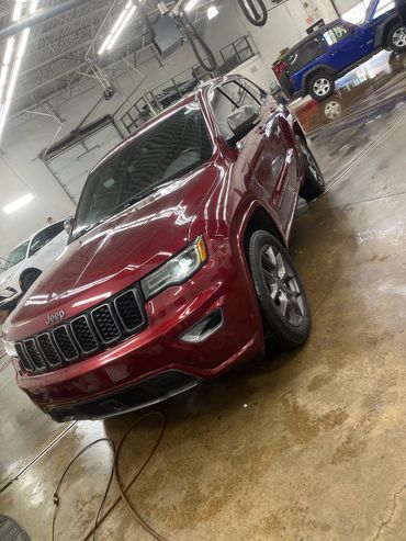 red jeep freshly washed in a dealership